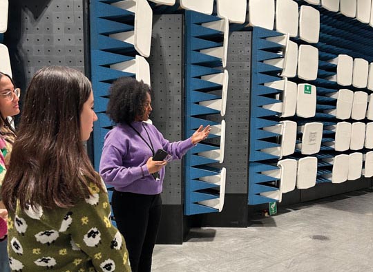 Young women listening to guide inside test chamber