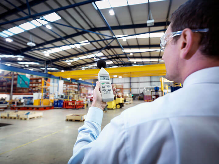 Close up view of consultant checking the decimal level of a warehouse room