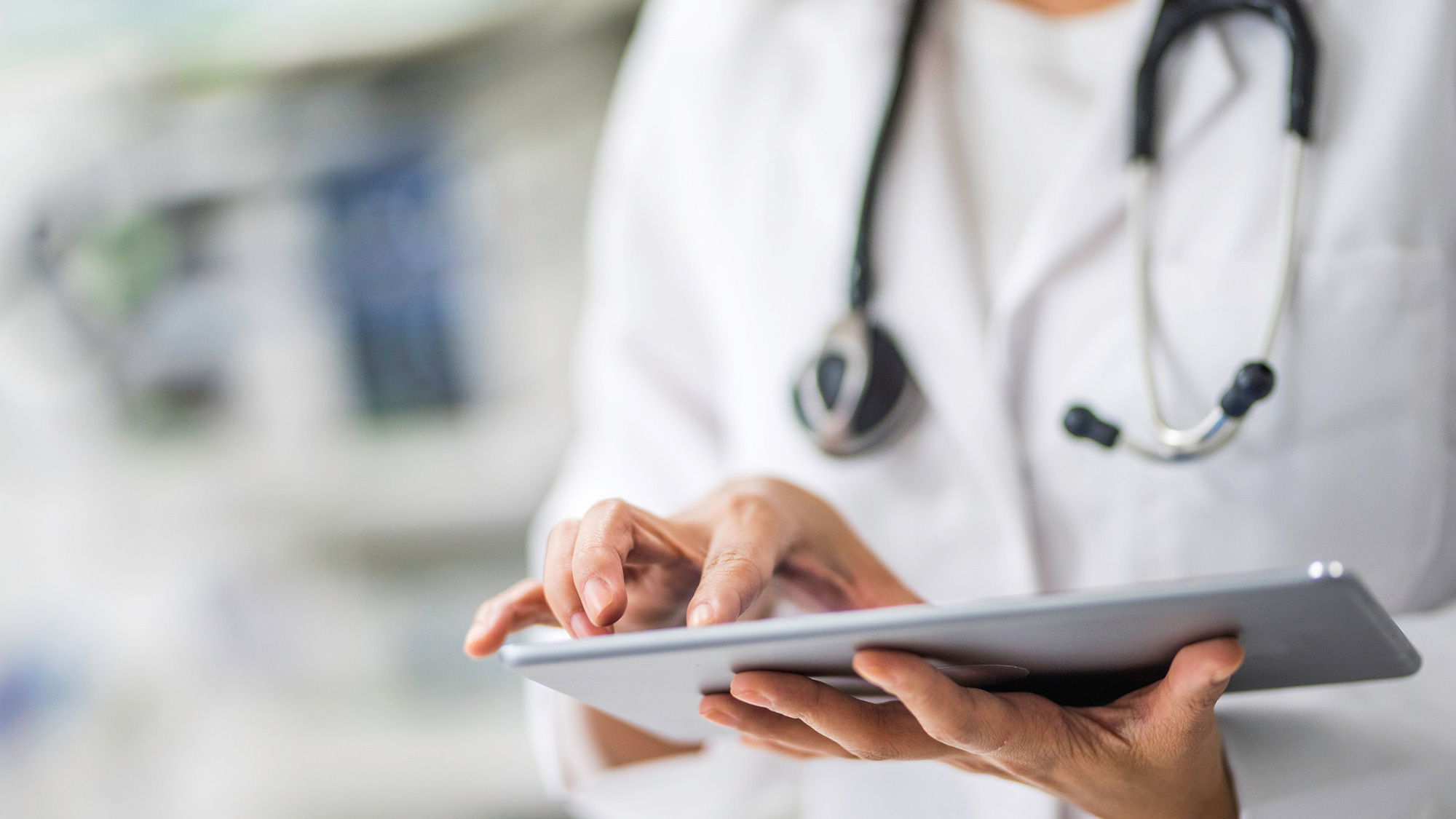 Female doctor using digital tablet in clinic